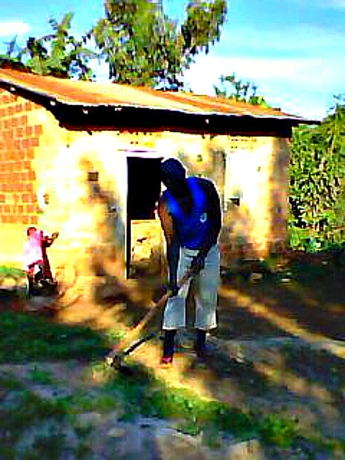 Clearing around my first home after prison, Buyongo Village Ndejje